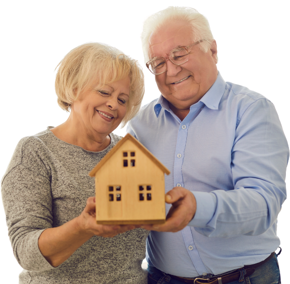 Senior couple holding a small model house